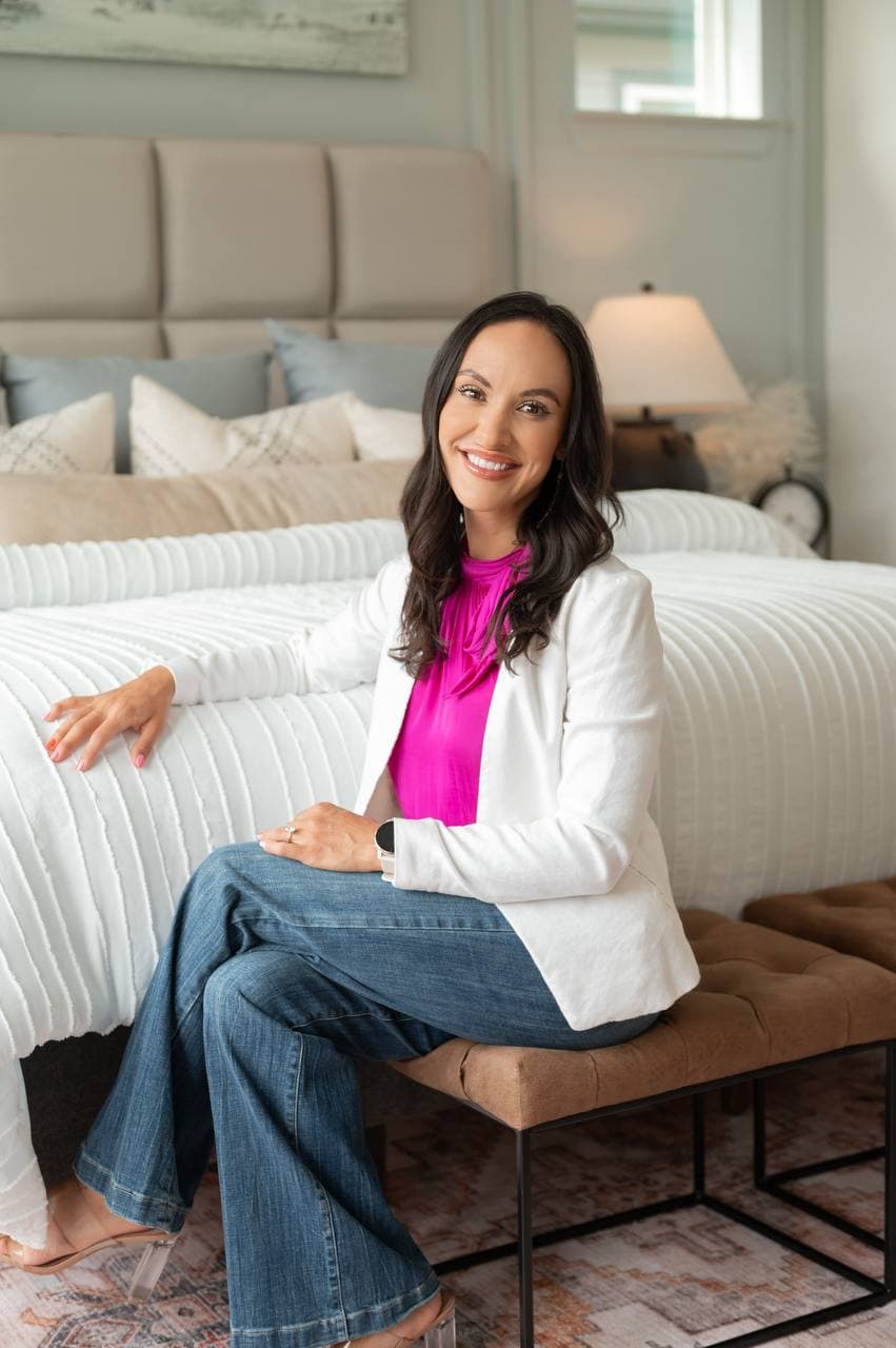 Leeanne Courville seated in a white blazer for personal Dallas–Fort Worth real estate guidance